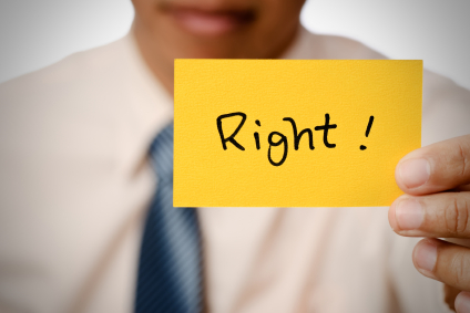 alt text image for a man holding a piece of paper with the word "right" written on it