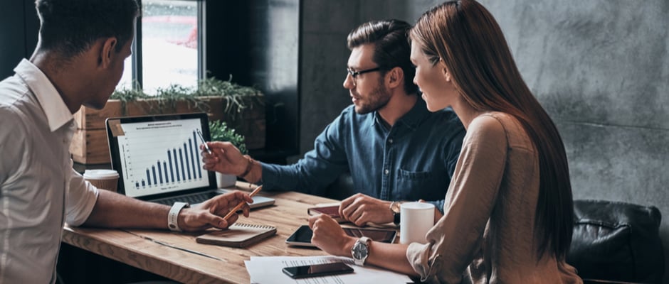 image of Group of young confident business people analyzing data using computer while spending time in the office