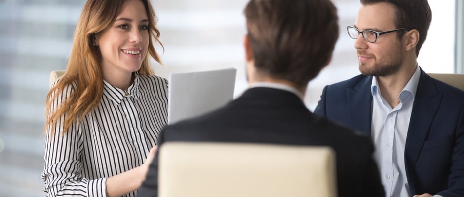 image of salespeople having a meeting around a table