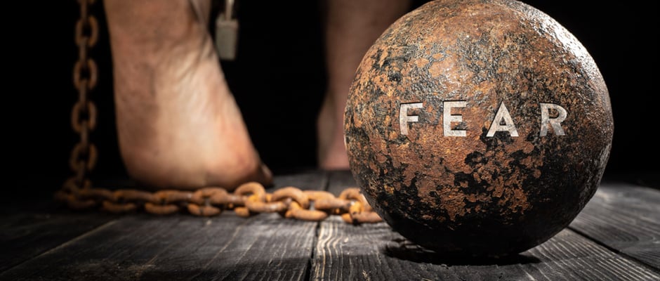 alt text image of a ball and chain with the word fear as a metaphor for 10 Fears You Can Turn Into Courageous Decisions