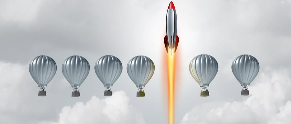 alt image text of rocket soaring above balloons to represent success
