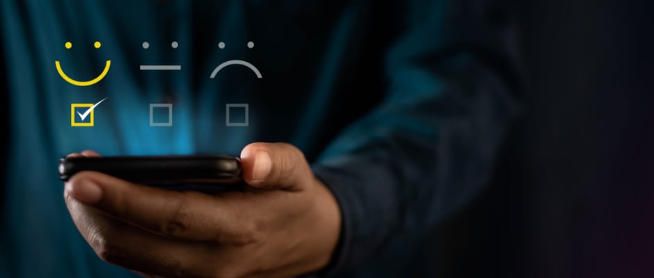 image of person's hand holding phone to rate their performance