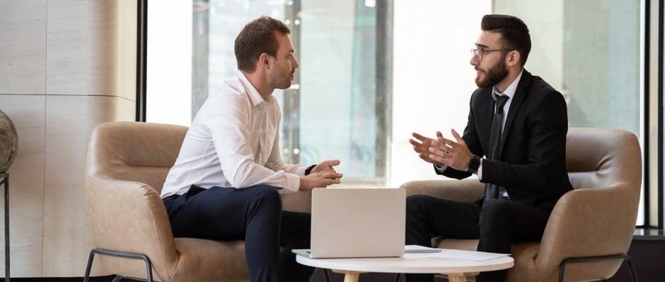 alt text image of two business men having a conversation