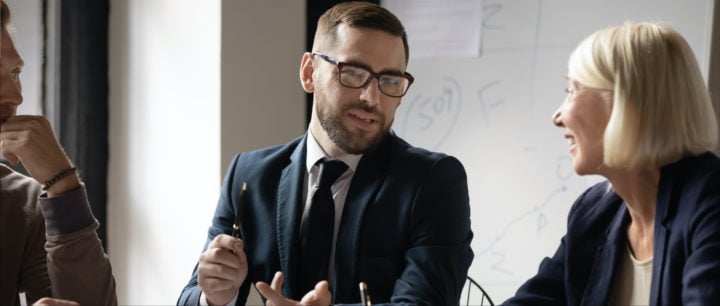 image of businessman talking with team at a table