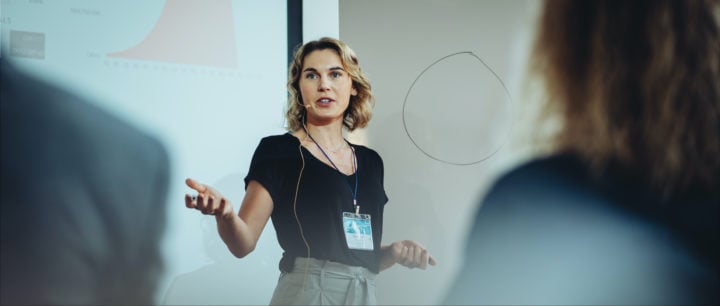 image of woman presenting to a group of people