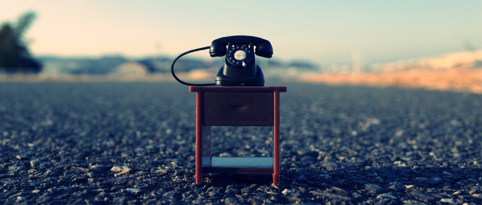 alt text image of rotary phone on table outside
