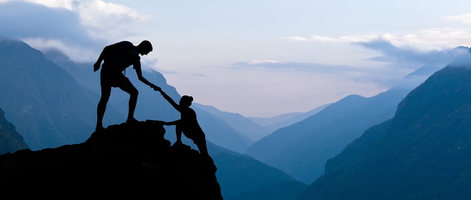 alt text image of a person helping another climb as a metaphor for 4 Rules for Overcoming Objections In a Downturn