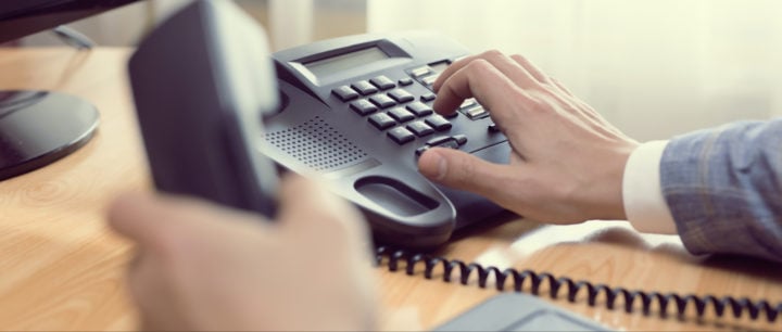 image of a man's hand making a phone call