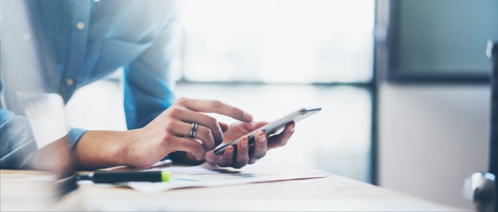 image of man looking at cell phone