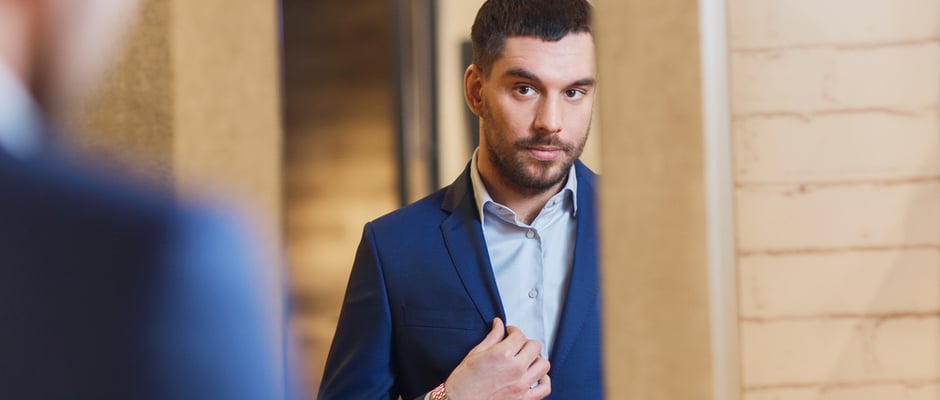 image of man looking in the mirror to represent the obstacle standing in your way