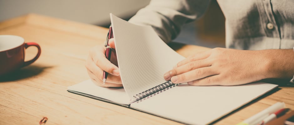 alt text image of a man writing in a notebook as a metaphor for How to Shift Out of Reactive Mode and Exercise Control