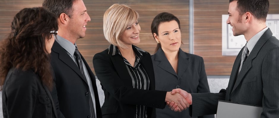 image of business woman shaking hands with business man