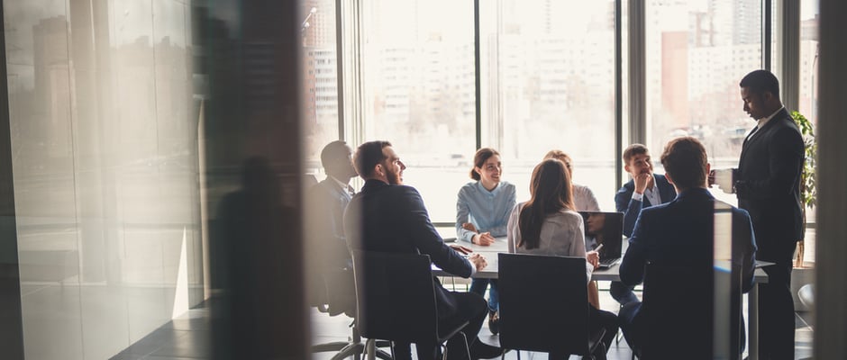 image of people gathered around a conference table