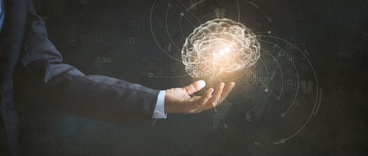 alt image text of a businessman holding a glowing brain to represent mindset