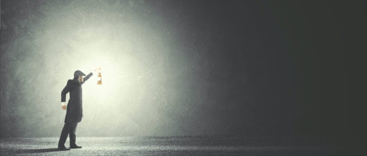 alt image text of man holding out a lantern illuminating the darkness to represent telling the truth