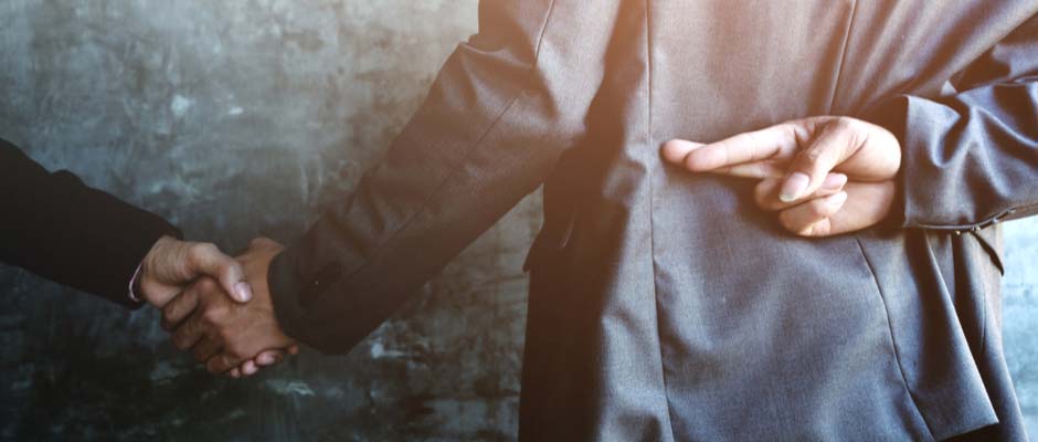 businessman with fingers crossed behind back