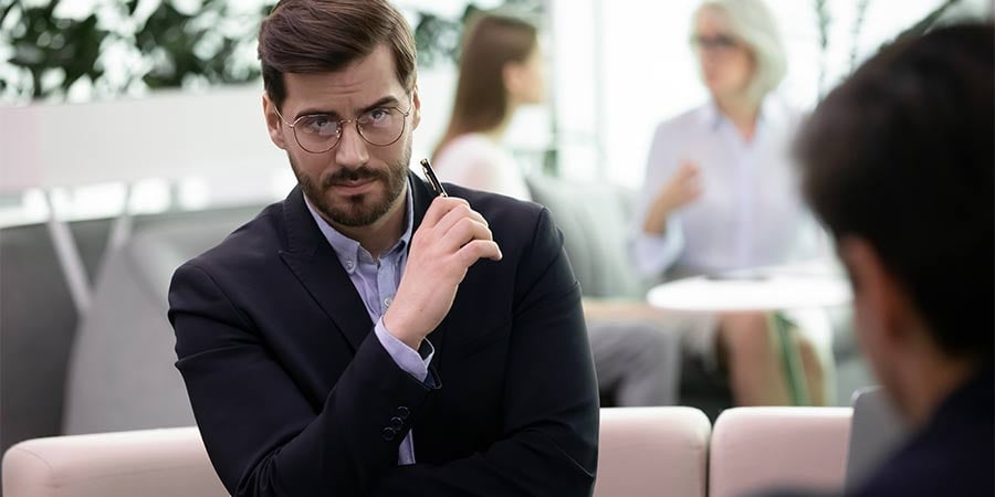 An annoyed doubting client looks at a salesman