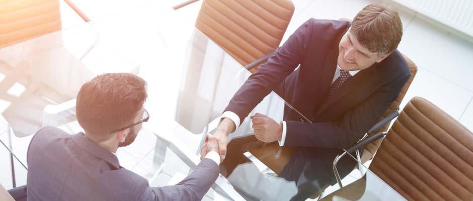 business handshake across table