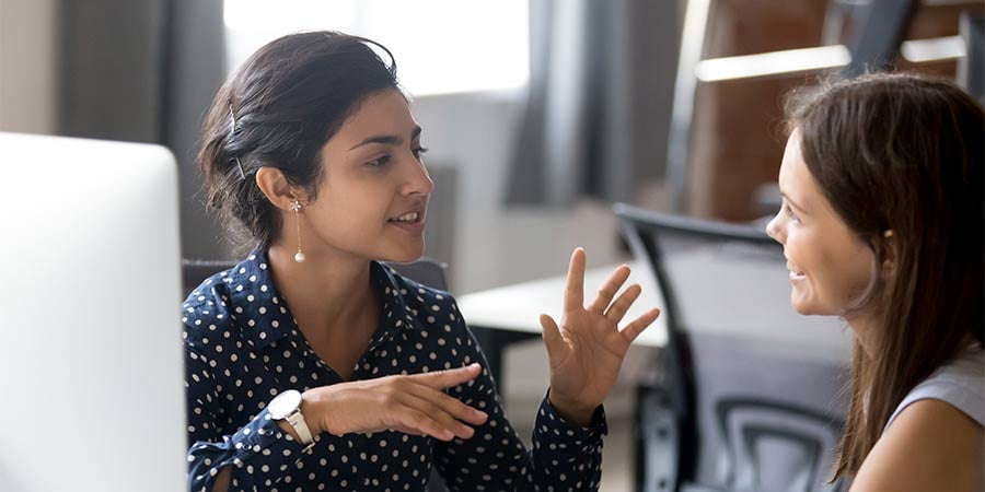 women providing personalized coaching to a saleswoman