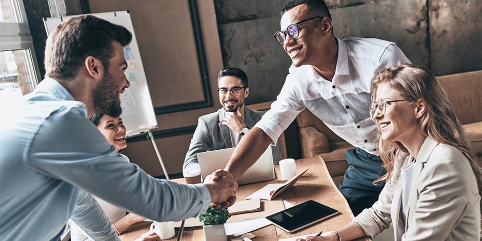 businessmen shaking hands at a table