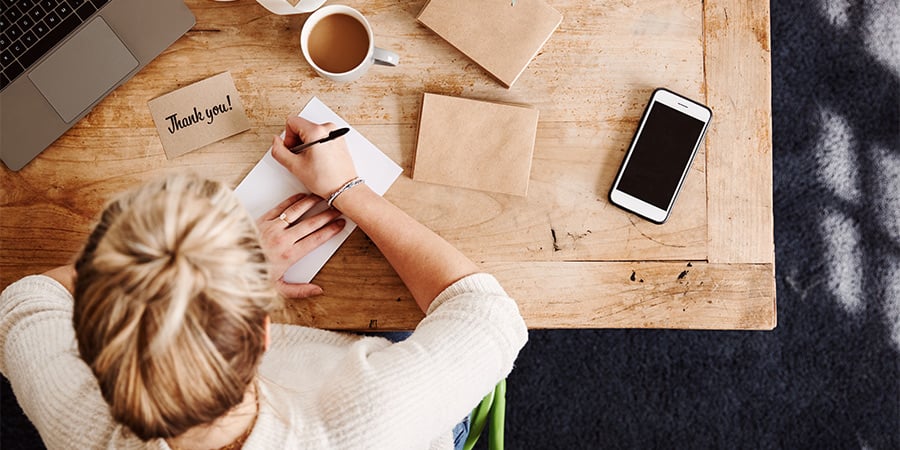 saleswoman writing thank you notes