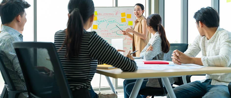 asian businesswoman leading a meeting