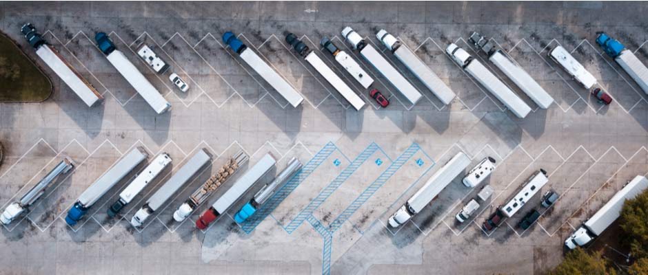 big rig trucks parked in lot