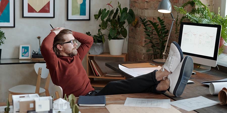 businessman with feet up on table