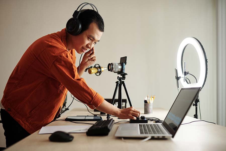 man setting up webcam and better lighting 