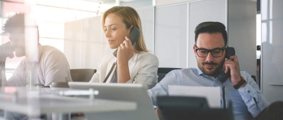 man and woman in office on sales calls