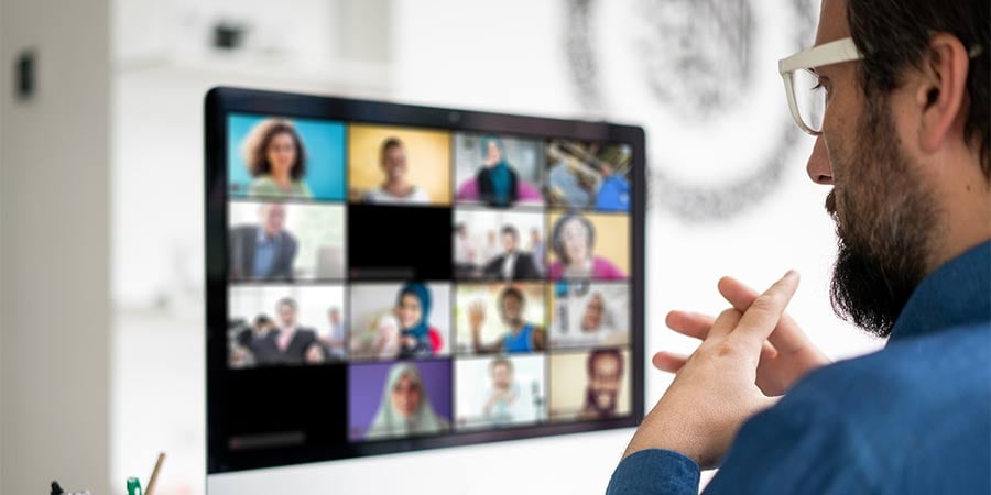 man at a computer in a virtual meeting