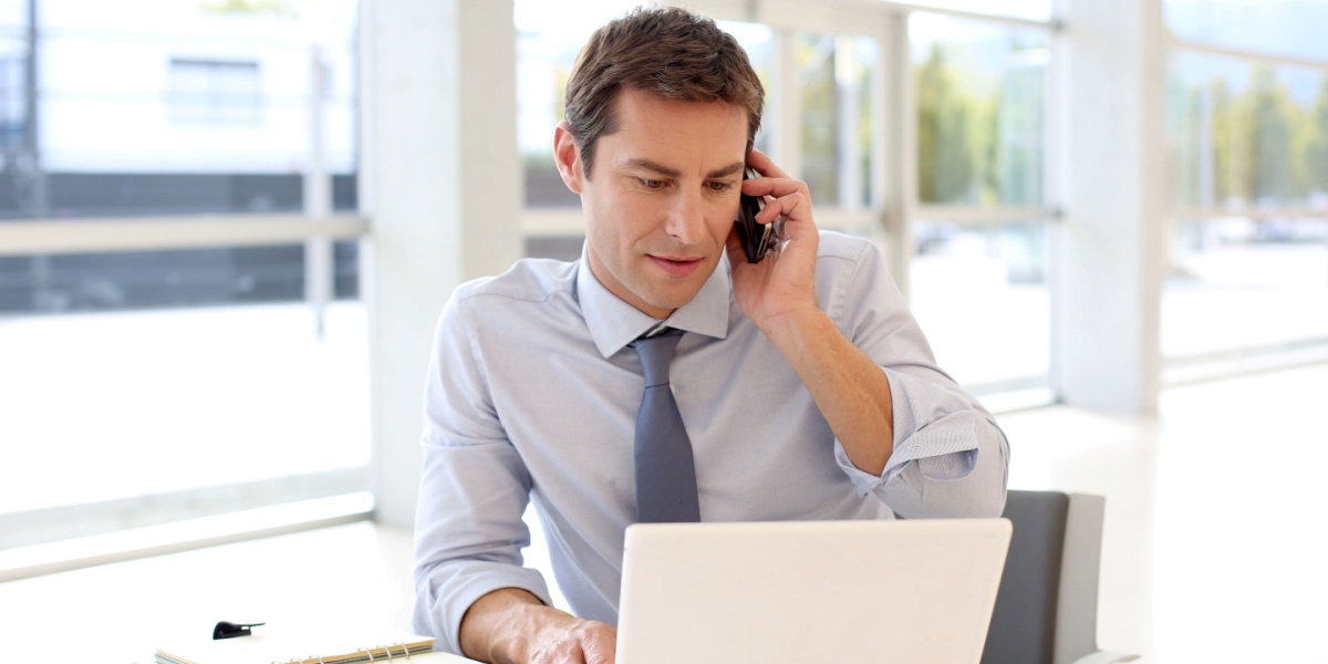 Salesman on phone and laptop