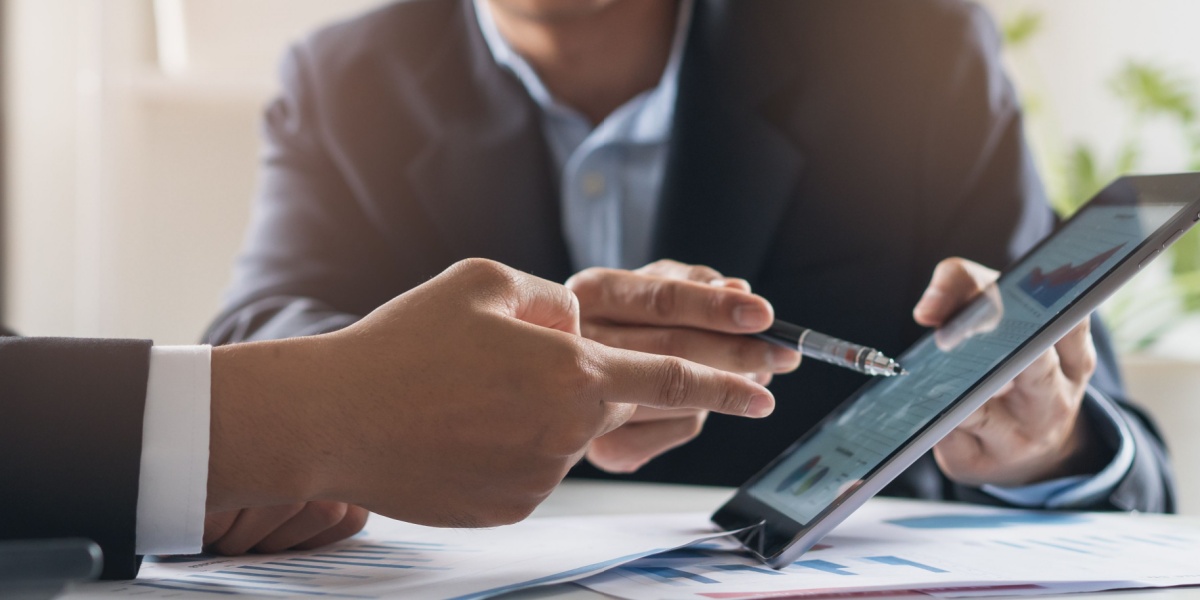 Businessman showing client data on tablet