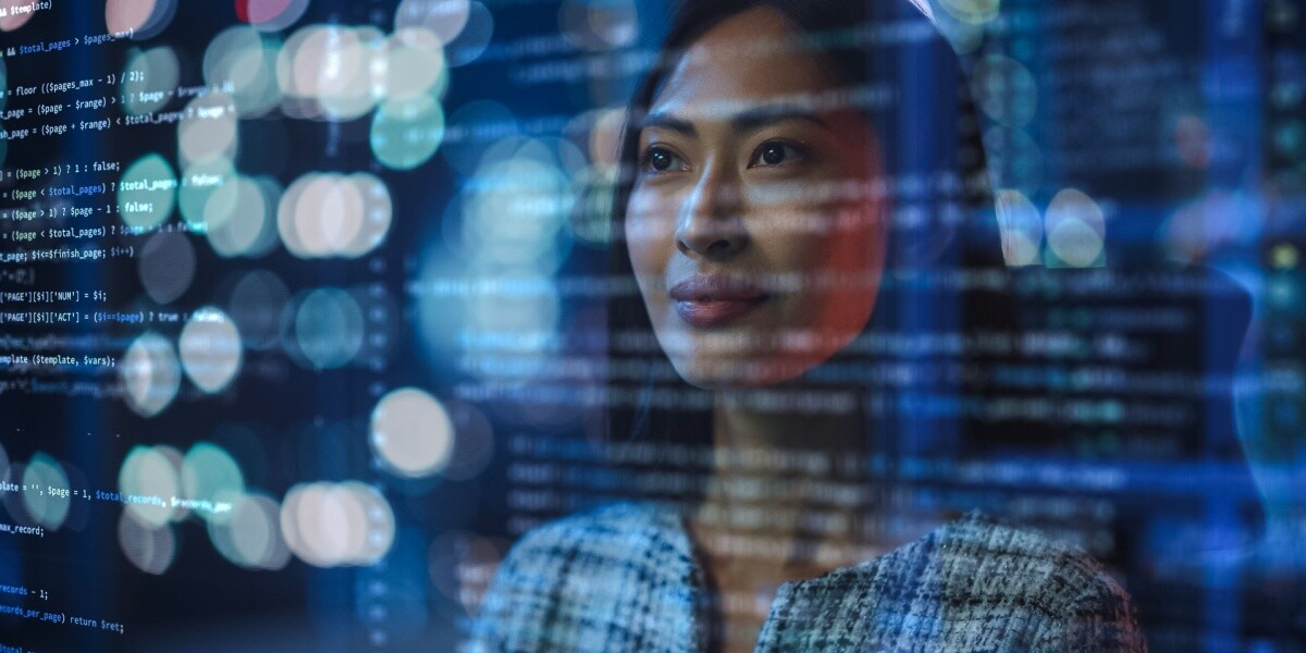 Businesswomen with blue lights and code in front of her