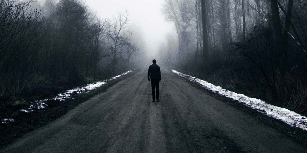 walking alone on a gloomy road