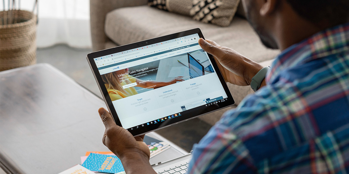 Man browsing Linkedin on a tablet
