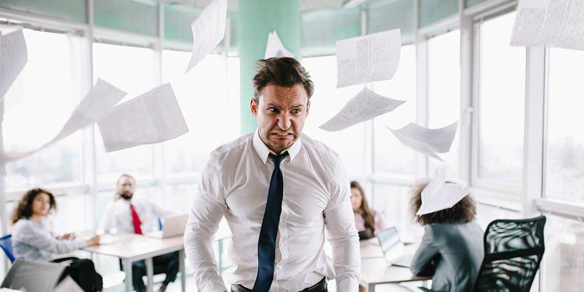Angry client storming out of a room with papers flying in the air