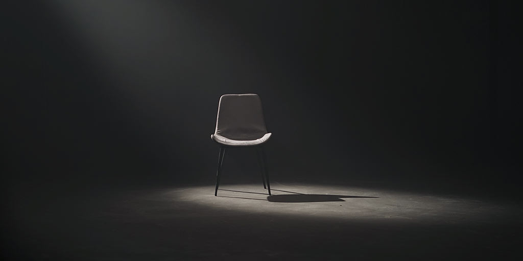 spotlight on an empty chair in a room