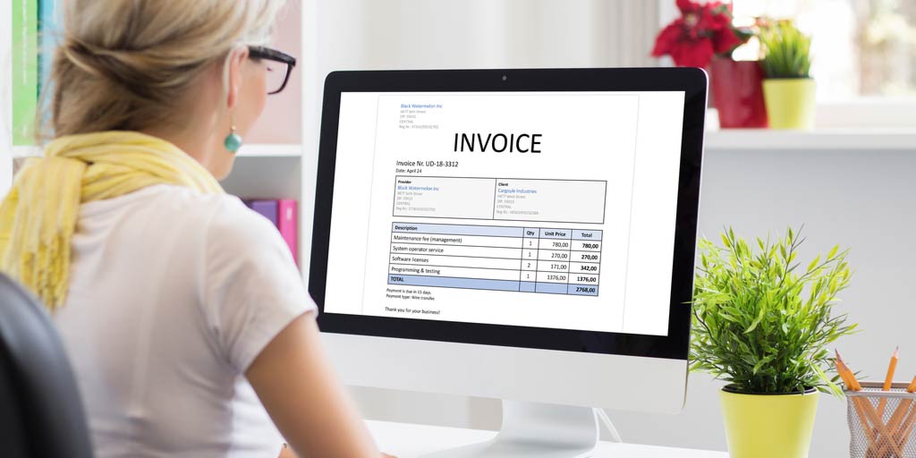 woman looking at invoice on a computer screen