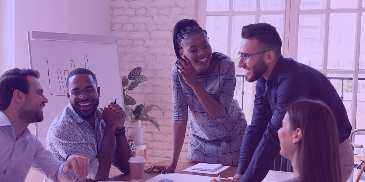 Sales team laughing in a meeting