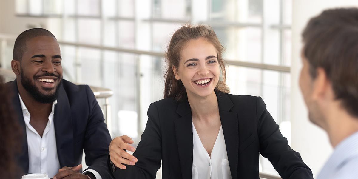 group of business people laughing in conversation
