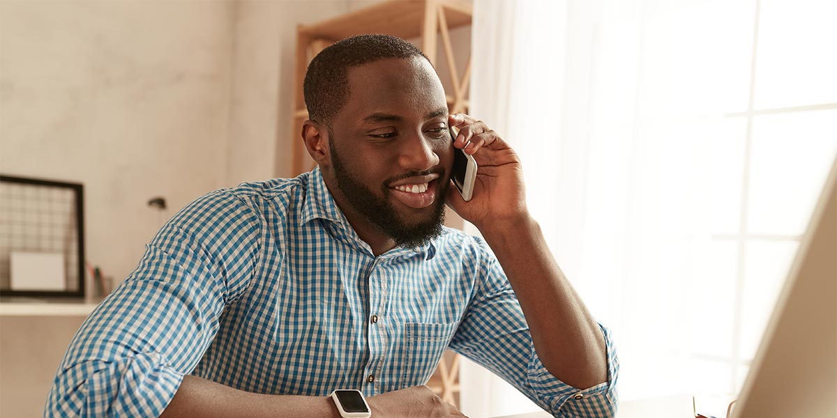 Young African American salesman talking on the phone