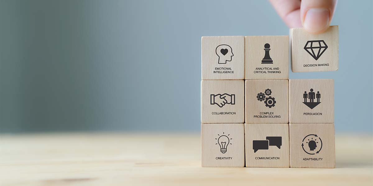 Stacking wooden blocks representing soft skills
