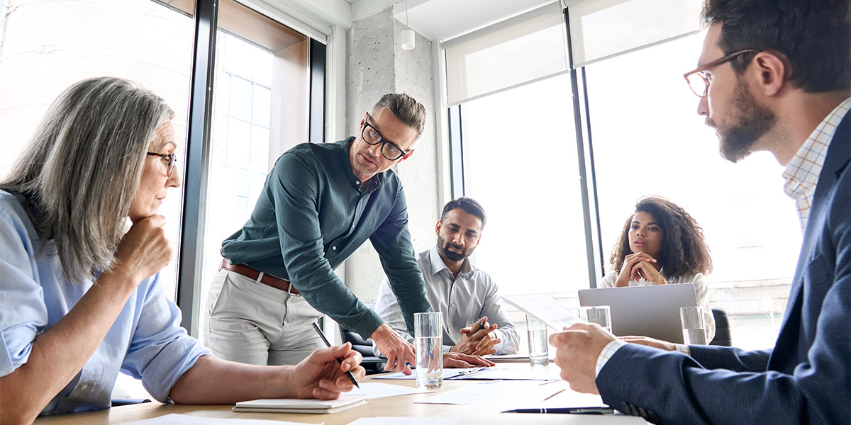 Salesman meeting with clients in a boardroom