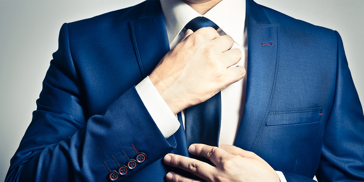 businessman adjusting his tie