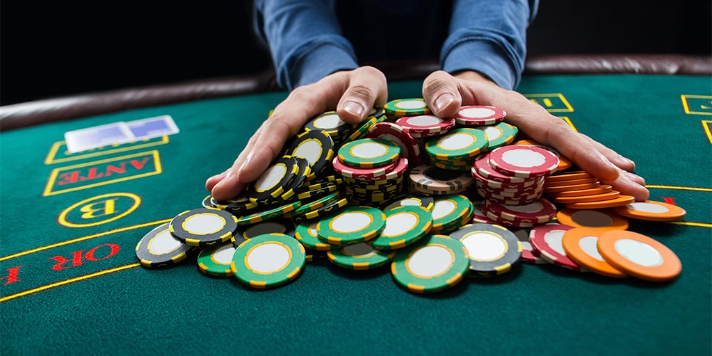 Man pushing all his poker chips in at the table