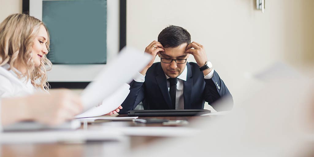 Stressed businessman in a meeting