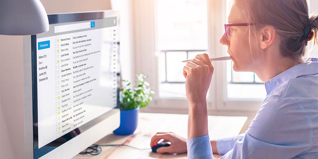 woman staring at email on computer screen