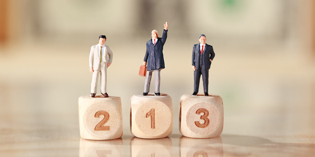 business figurines on a 123 podium