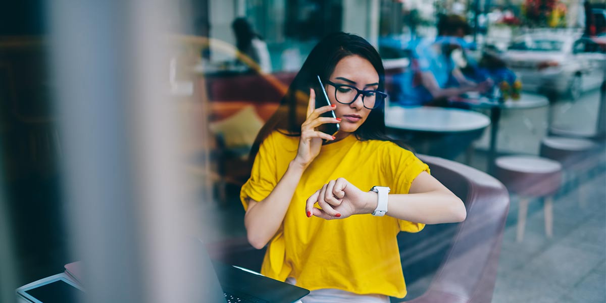 businesswoman on the phone checking her watch